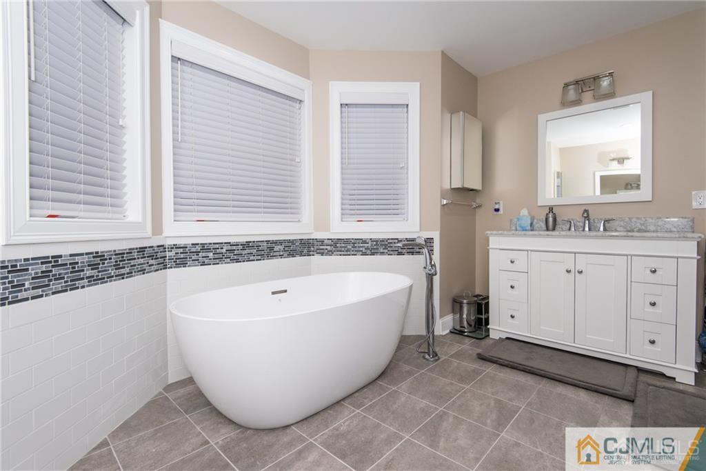 42 Idlewild Road Edison, NJ 08817 - Photo 36 of 43 a spacious bathroom with a bathtub and window