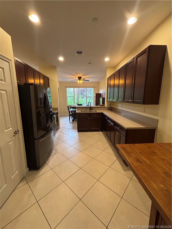 262 Southwest Walking Path, Unit 262 Stuart, FL 34997 - Photo 1 of 39 a large kitchen with a large counter top space and stainless steel appliances