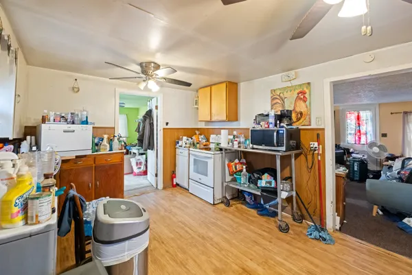 a room with furniture a flat screen tv and a dining table