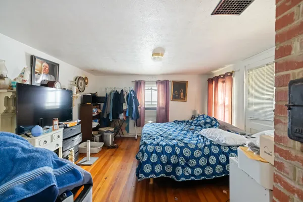 a bedroom with a bed and a flat screen tv