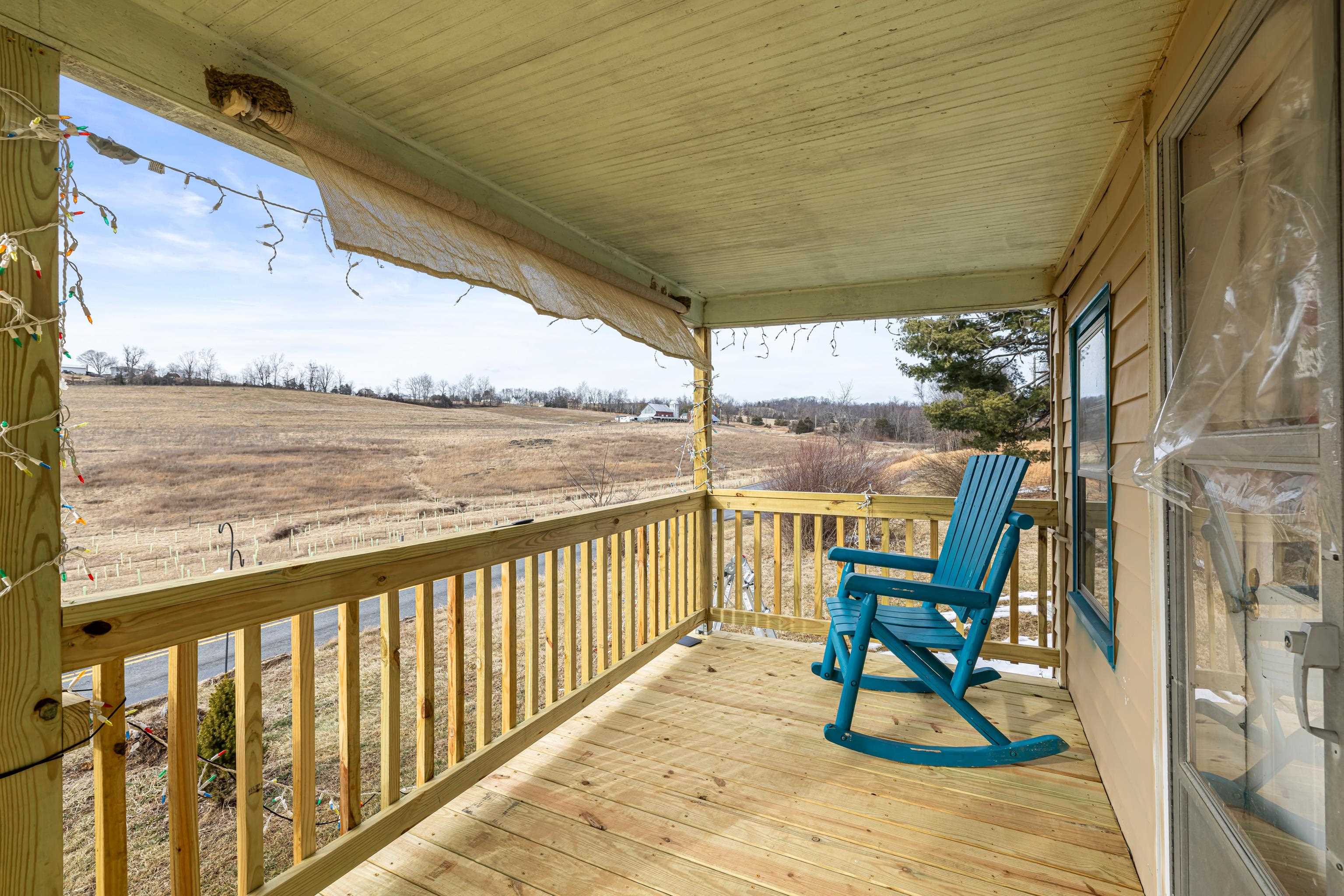 394 Ridge Road Raphine, VA 24472 - Photo 2 of 46 a view of a balcony with chairs and wooden floor