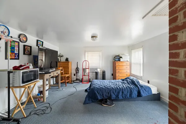 a bedroom with furniture a bed and a flat screen tv