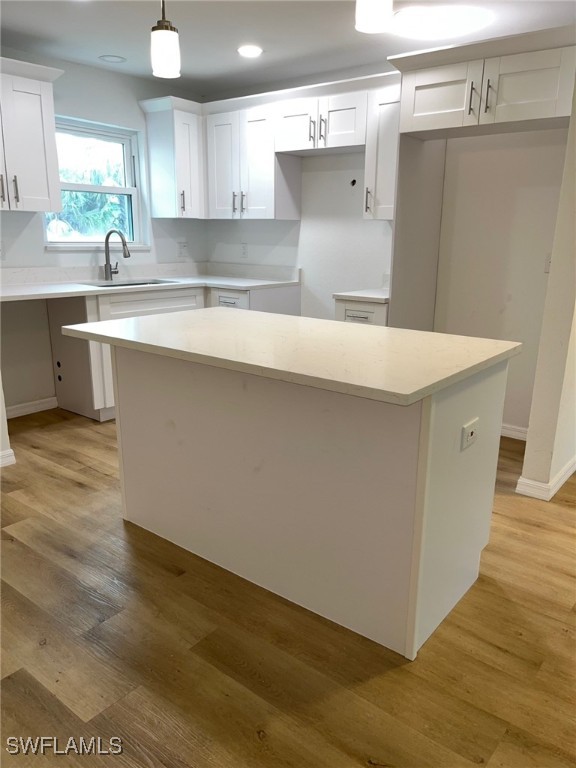 16881 Davis Road, Unit 713 Fort Myers, FL 33908 - Photo 1 of 29 a kitchen with a sink cabinets and wooden floor