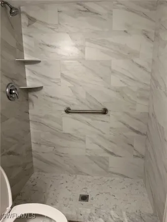 a bathroom with a toilet sink and shower
