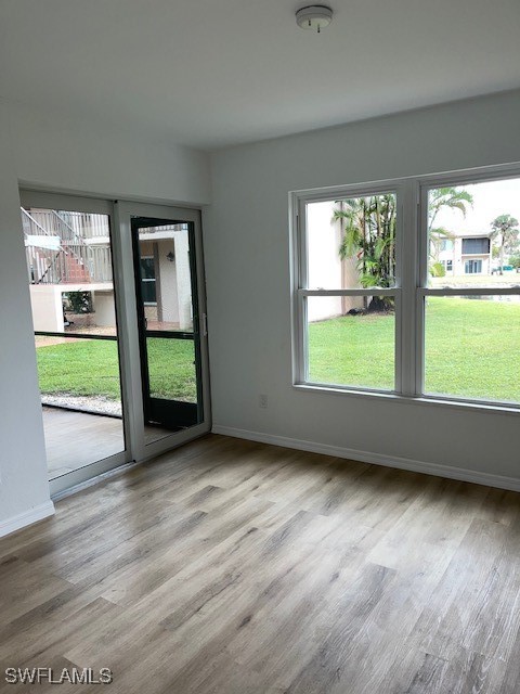 16881 Davis Road, Unit 713 Fort Myers, FL 33908 - Photo 15 of 29 a view of an empty room with wooden floor and a window