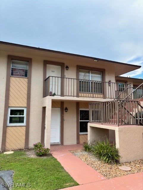 16881 Davis Road, Unit 713 Fort Myers, FL 33908 - Photo 2 of 29 a front view of a house with a yard and a porch