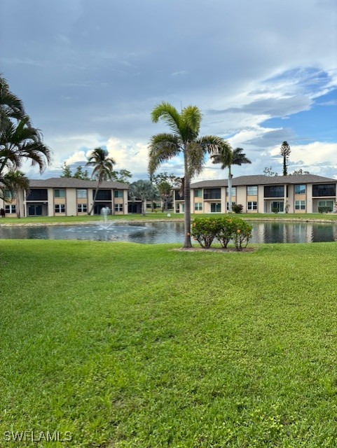16881 Davis Road, Unit 713 Fort Myers, FL 33908 - Photo 22 of 29 a front view of residential houses with yard and green space