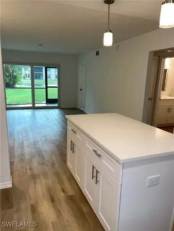 a kitchen that has a lot of cabinets furniture and a window