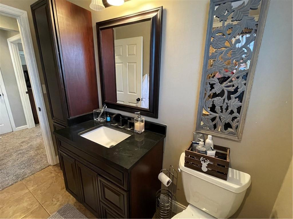 233 Teepee Road Canonsburg, PA 15317 - Photo 20 of 25 a bathroom with a granite countertop sink a toilet a mirror and shower curtain