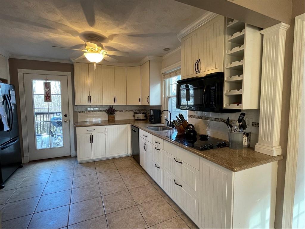 233 Teepee Road Canonsburg, PA 15317 - Photo 8 of 25 a kitchen with stainless steel appliances a stove sink microwave and cabinets