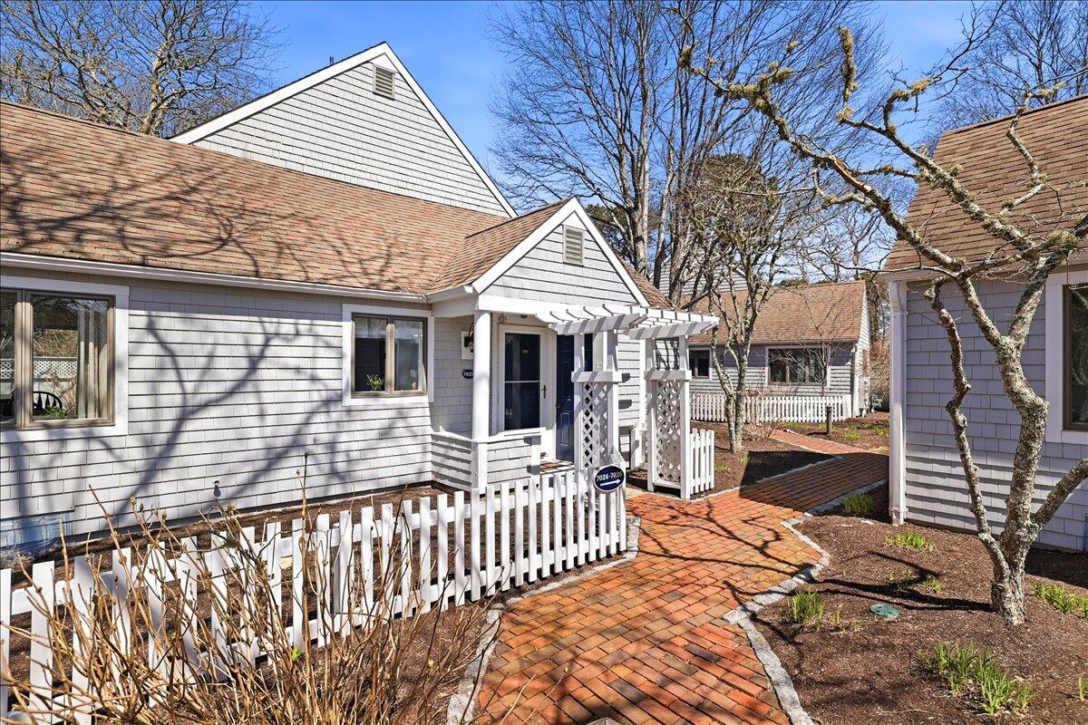 100 Mid-Iron Way, Unit 7027 Mashpee, MA 02649 - Photo 2 of 38 a front view of house with wooden deck