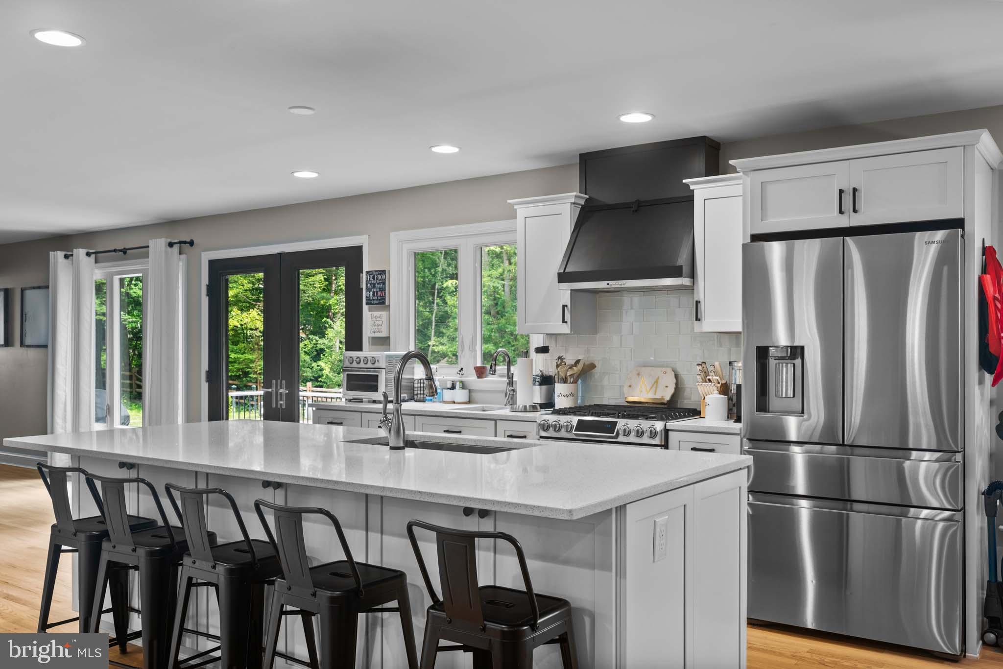 122 Hitching Post Drive Wilmington, DE 19803 - Photo 35 of 64 a kitchen with stainless steel appliances granite countertop a refrigerator a sink a stove a dining table and chairs