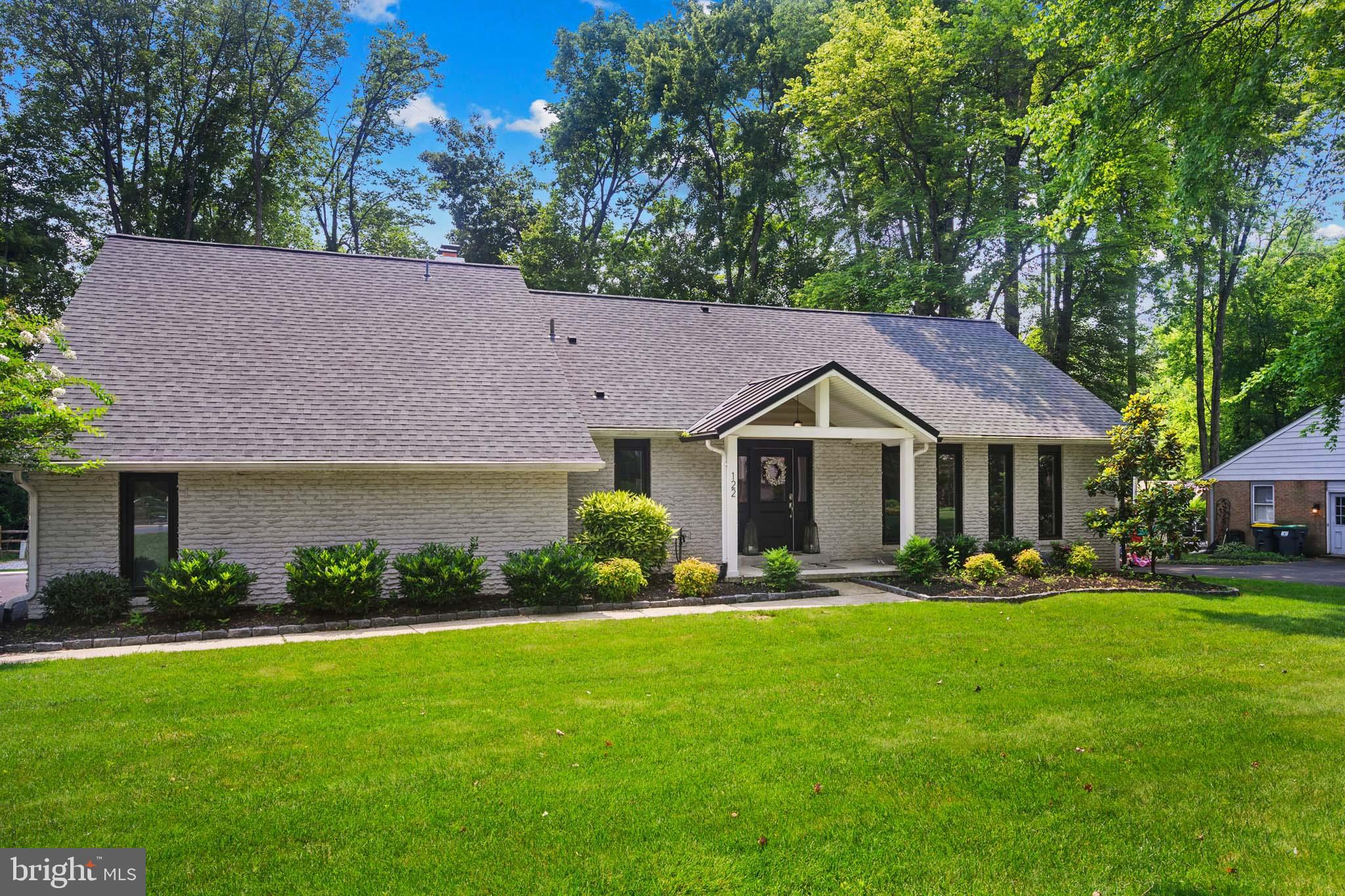 122 Hitching Post Drive Wilmington, DE 19803 - Photo 5 of 64 a front view of a house with a yard and trees