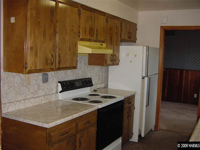 1169 Charles Place Reno, NV 89509 - Photo 4 of 7 a kitchen with a refrigerator and a stove top oven
