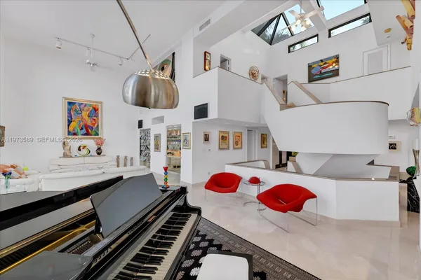 a living room with furniture gym equipment and large window