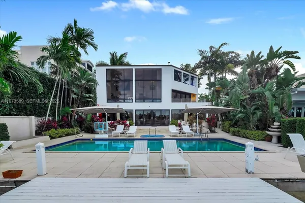 a view of swimming pool with outdoor seating and a patio