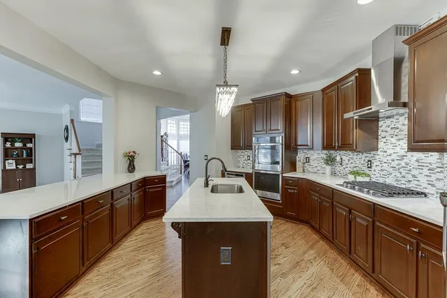 a kitchen with counter top space sink stainless steel appliances and cabinets