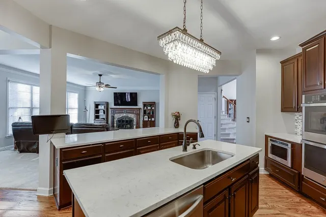 a kitchen with a stove a sink and a refrigerator