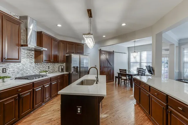 a kitchen with lots of counter top space a sink appliances and cabinets