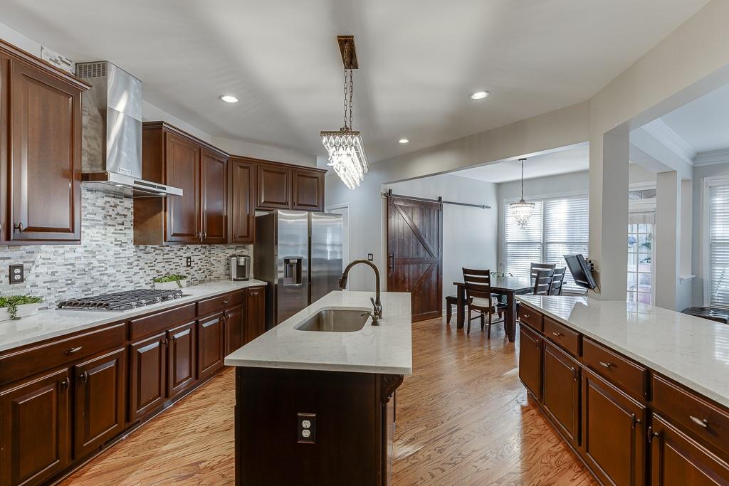 1806 Asteria Court Duluth, GA 30097 - Photo 20 of 63 a kitchen with lots of counter top space a sink appliances and cabinets