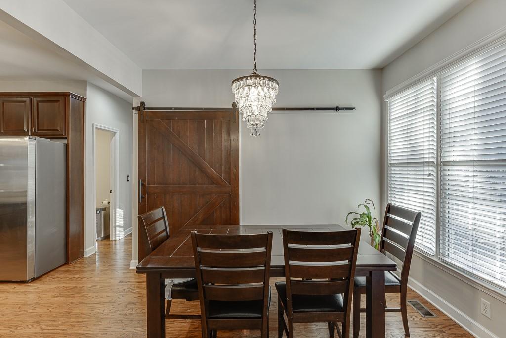 1806 Asteria Court Duluth, GA 30097 - Photo 21 of 63 a view of a dining room with furniture window and wooden floor