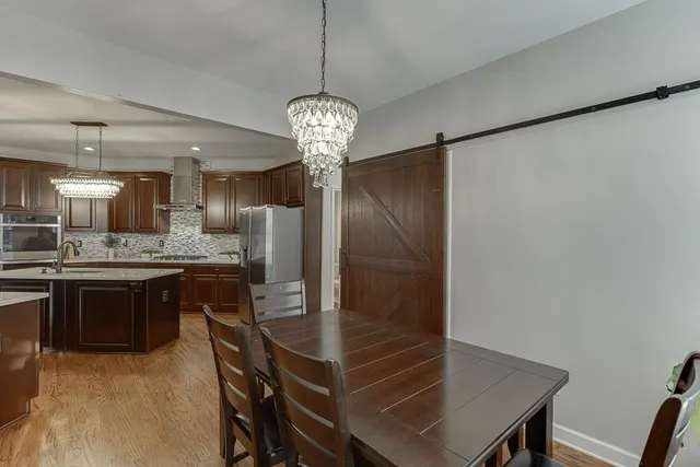 a large living room with stainless steel appliances kitchen island granite countertop furniture