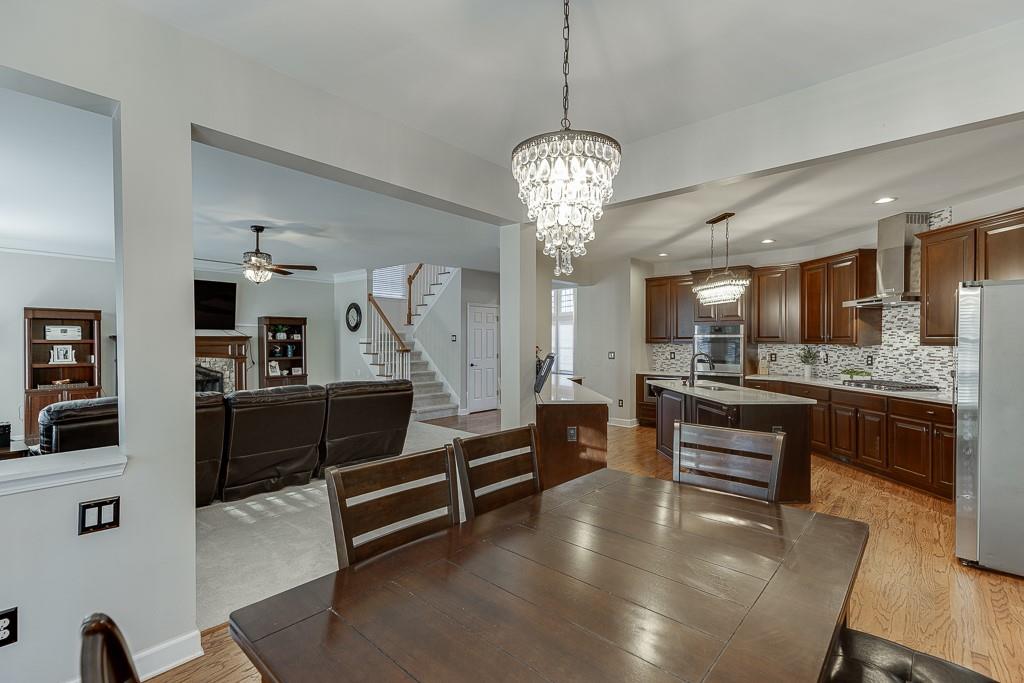 1806 Asteria Court Duluth, GA 30097 - Photo 23 of 63 a large living room with stainless steel appliances kitchen island granite countertop furniture