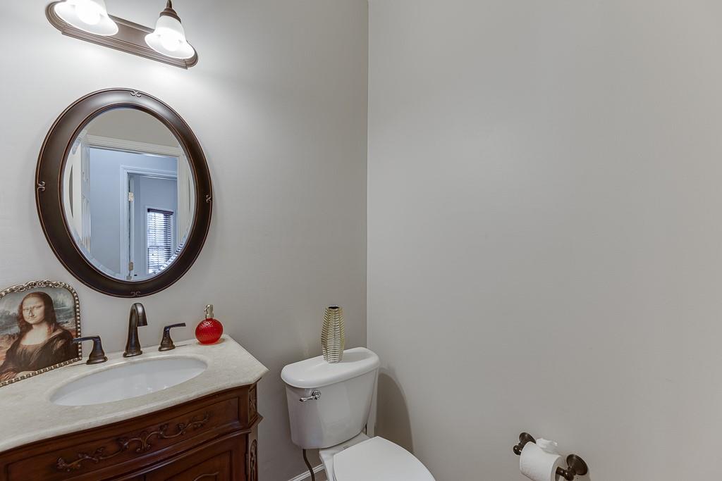 1806 Asteria Court Duluth, GA 30097 - Photo 24 of 63 a bathroom with a sink a toilet and a mirror