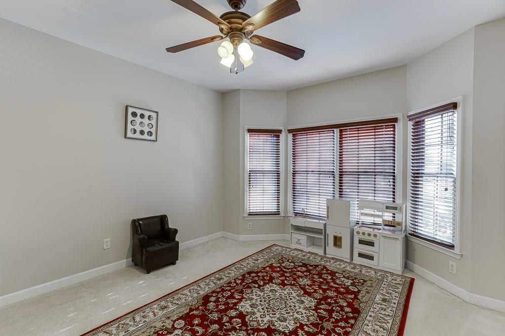 1806 Asteria Court Duluth, GA 30097 - Photo 25 of 63 a living room with a couch and a rug