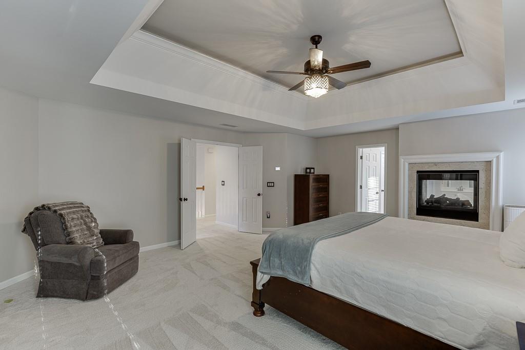 1806 Asteria Court Duluth, GA 30097 - Photo 29 of 63 a bedroom with a bed furniture and a ceiling fan