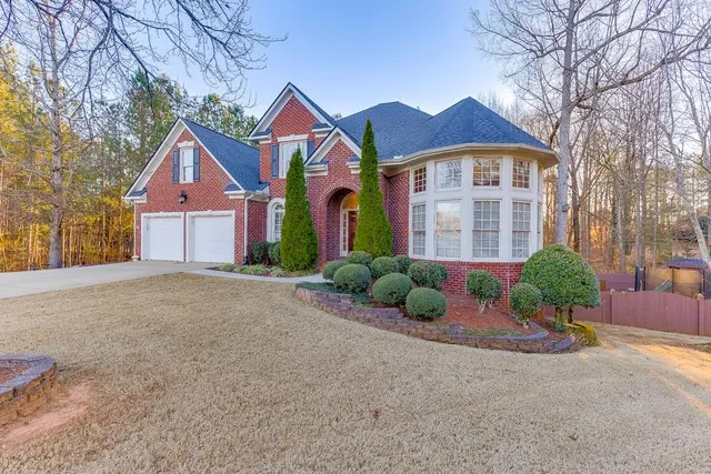 a front view of a house with a yard and garage