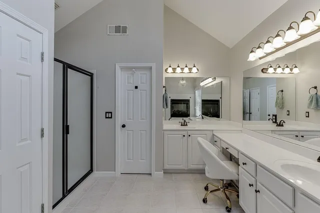 a bedroom with a bed and a ceiling fan