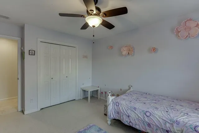 a bedroom with bed and a chandelier