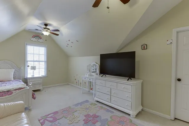a bedroom with a bed chandelier and a window