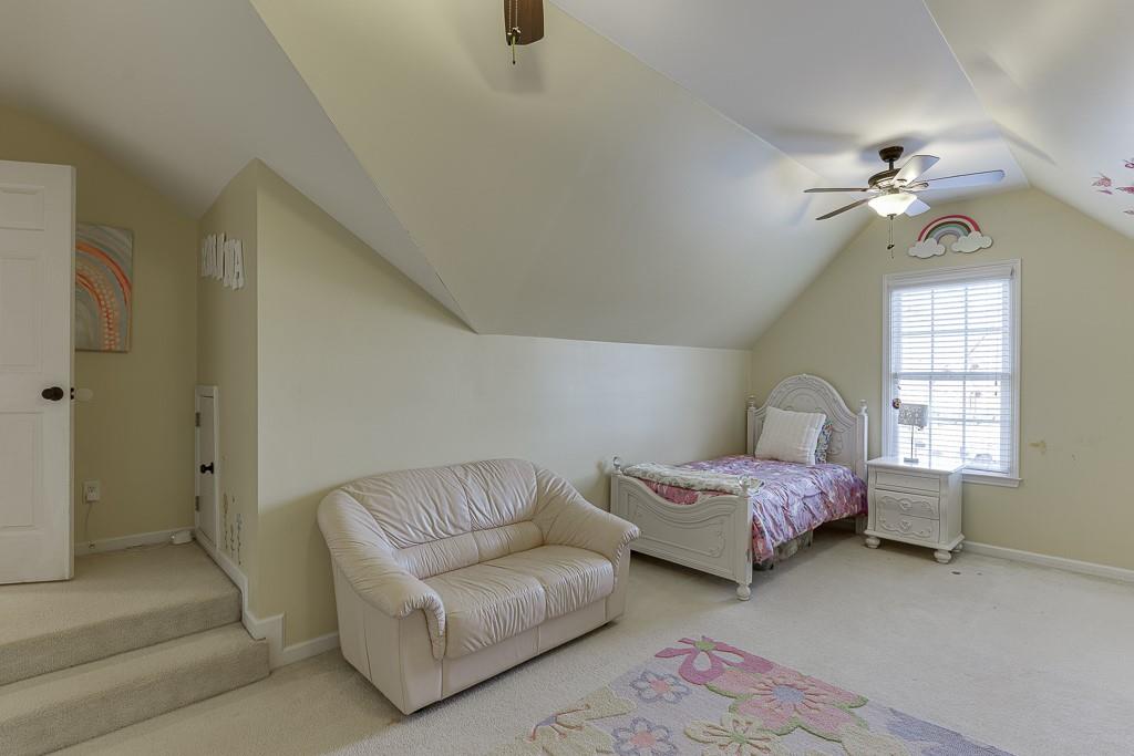 1806 Asteria Court Duluth, GA 30097 - Photo 37 of 63 a bedroom with a bed couch chandelier and a window