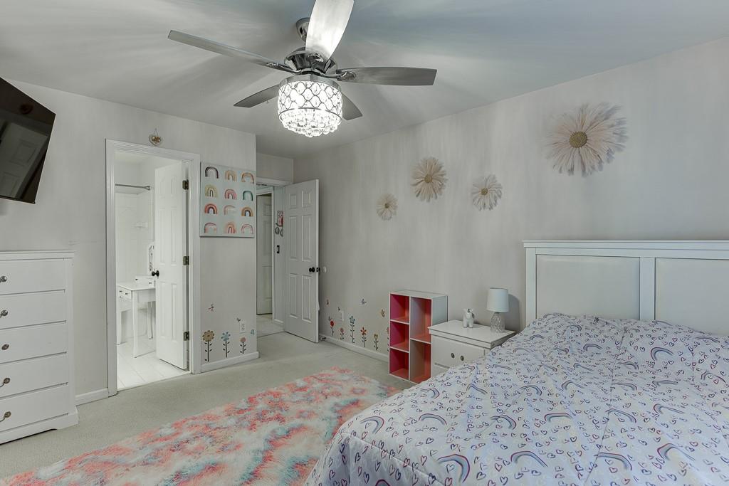 1806 Asteria Court Duluth, GA 30097 - Photo 40 of 63 a bedroom with a bed and a chandelier