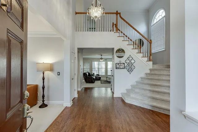a view of entryway and hall with wooden floor