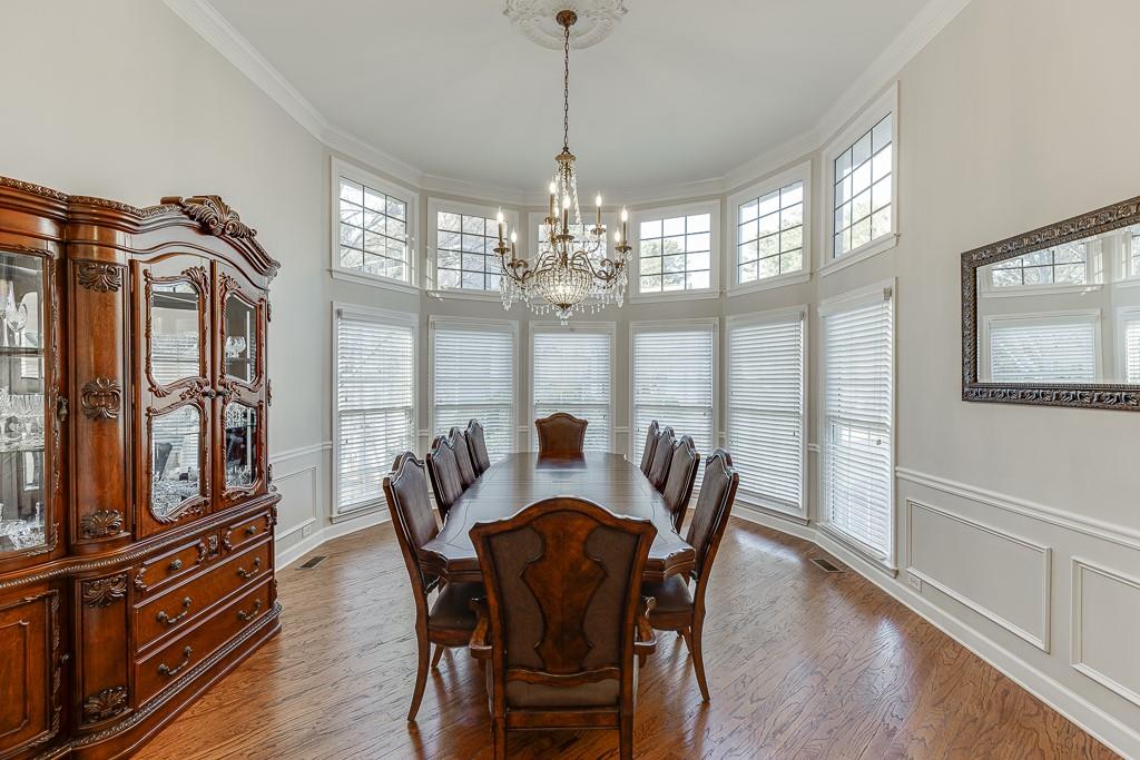 1806 Asteria Court Duluth, GA 30097 - Photo 5 of 63 a view of a dining room with furniture a chandelier and wooden floor