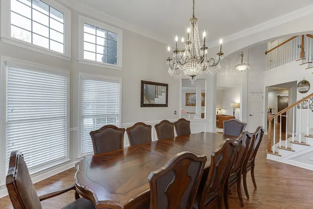 a view of a dining room with furniture and chandelier