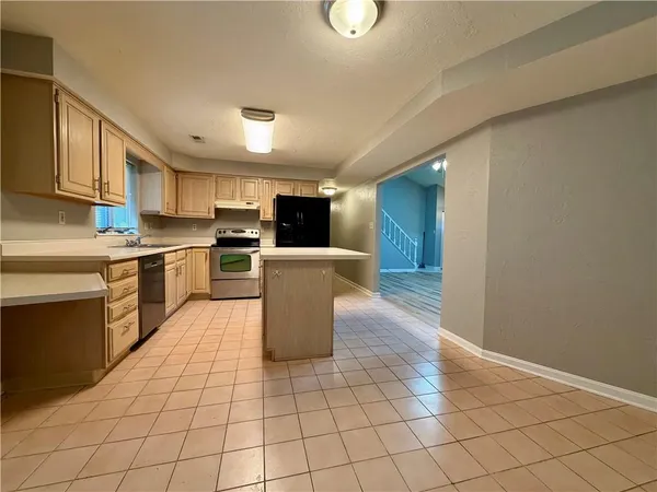 a kitchen with a sink a counter top space cabinets and stainless steel appliances