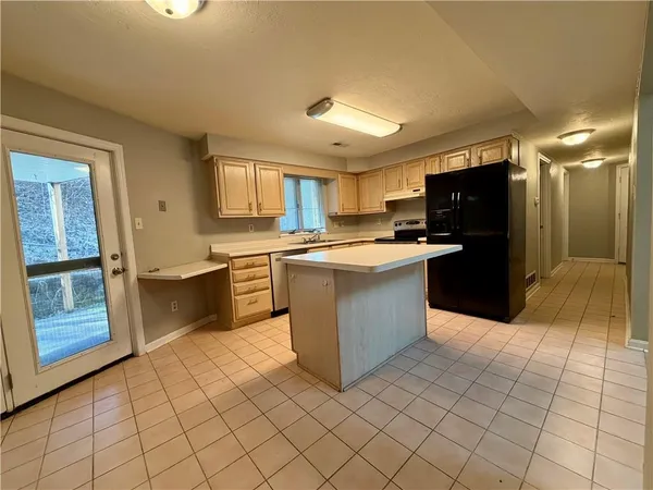 a kitchen with stainless steel appliances granite countertop a stove top oven a sink a counter top space and cabinets