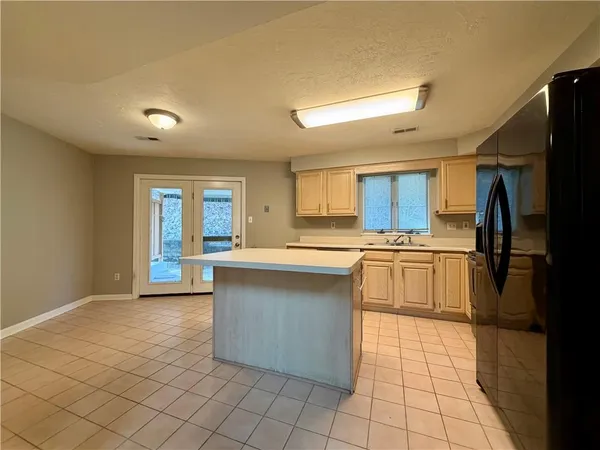 a large kitchen with cabinets and stainless steel appliances