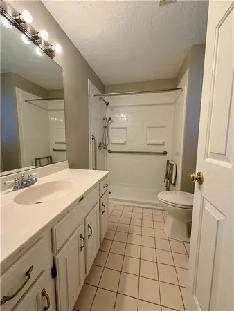 a bathroom with a sink a toilet and mirror