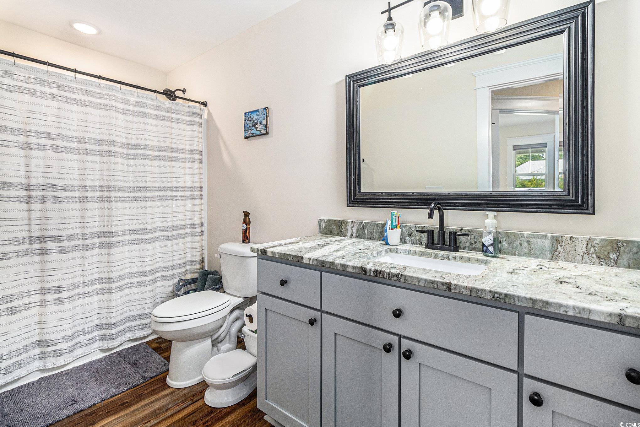 2895 Graham Road Conway, SC 29526 - Photo 22 of 31 Full bathroom with vanity, wood finished floors, and a shower with curtain