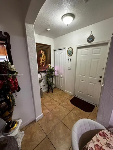 a bedroom with a bed and a wooden floor