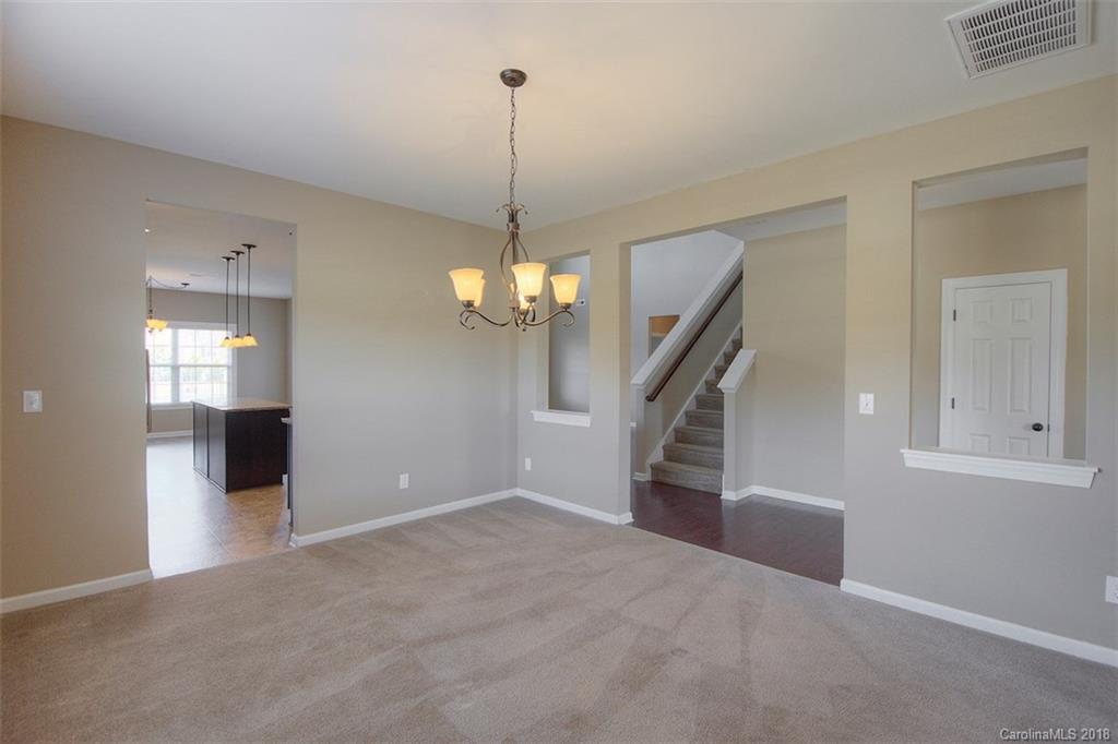 2001 Spring Rose Lane Wesley Chapel, NC 28104 - Photo 15 of 36 a view of a livingroom with wooden floor and stairs