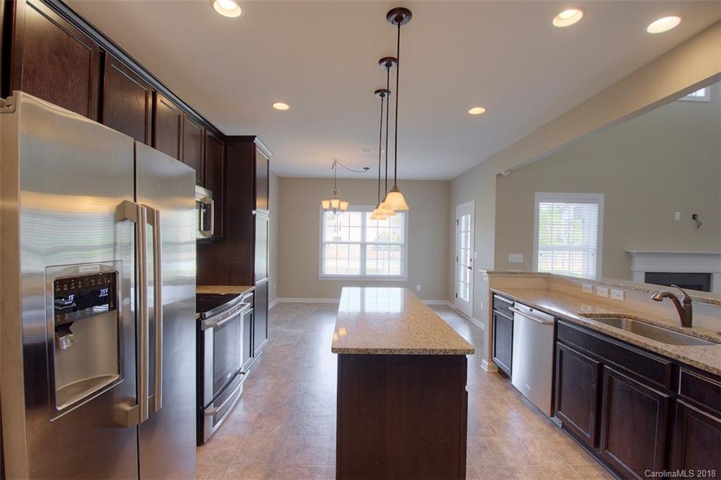 2001 Spring Rose Lane Wesley Chapel, NC 28104 - Photo 20 of 36 a kitchen with stainless steel appliances granite countertop a refrigerator a sink and a stove