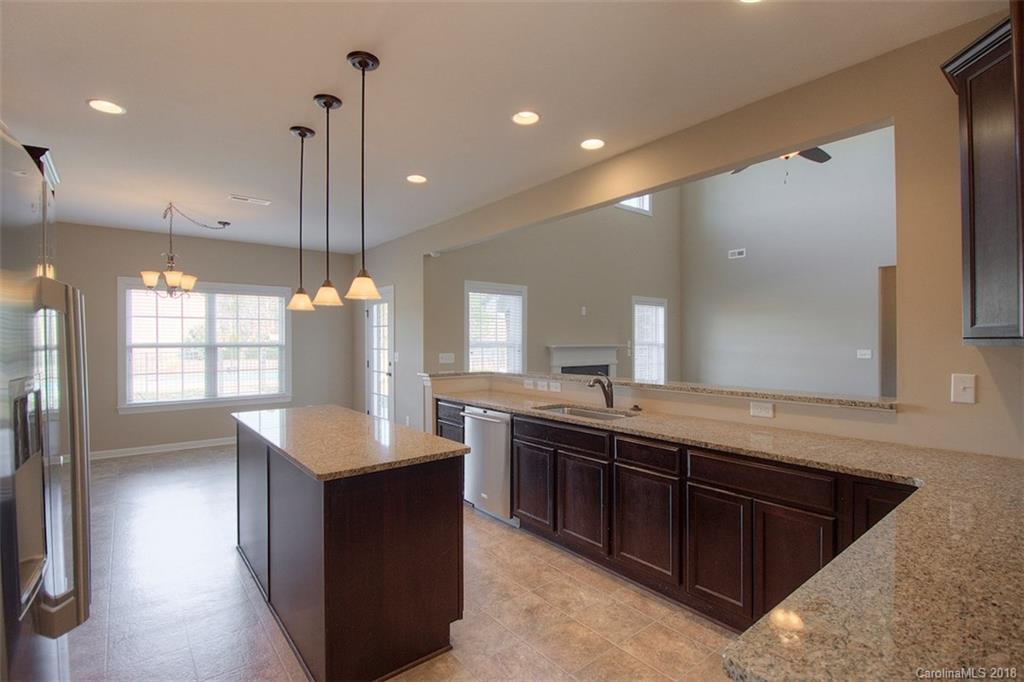 2001 Spring Rose Lane Wesley Chapel, NC 28104 - Photo 21 of 36 a large kitchen with kitchen island a sink stainless steel appliances and a counter top