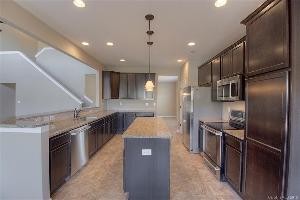 2001 Spring Rose Lane Wesley Chapel, NC 28104 - Photo 24 of 36 a kitchen with stainless steel appliances granite countertop a sink and a refrigerator