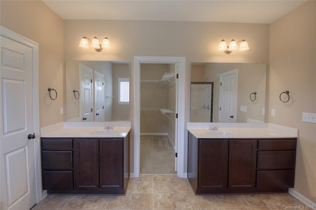 2001 Spring Rose Lane Wesley Chapel, NC 28104 - Photo 29 of 36 a bathroom with a double vanity sink and a mirror